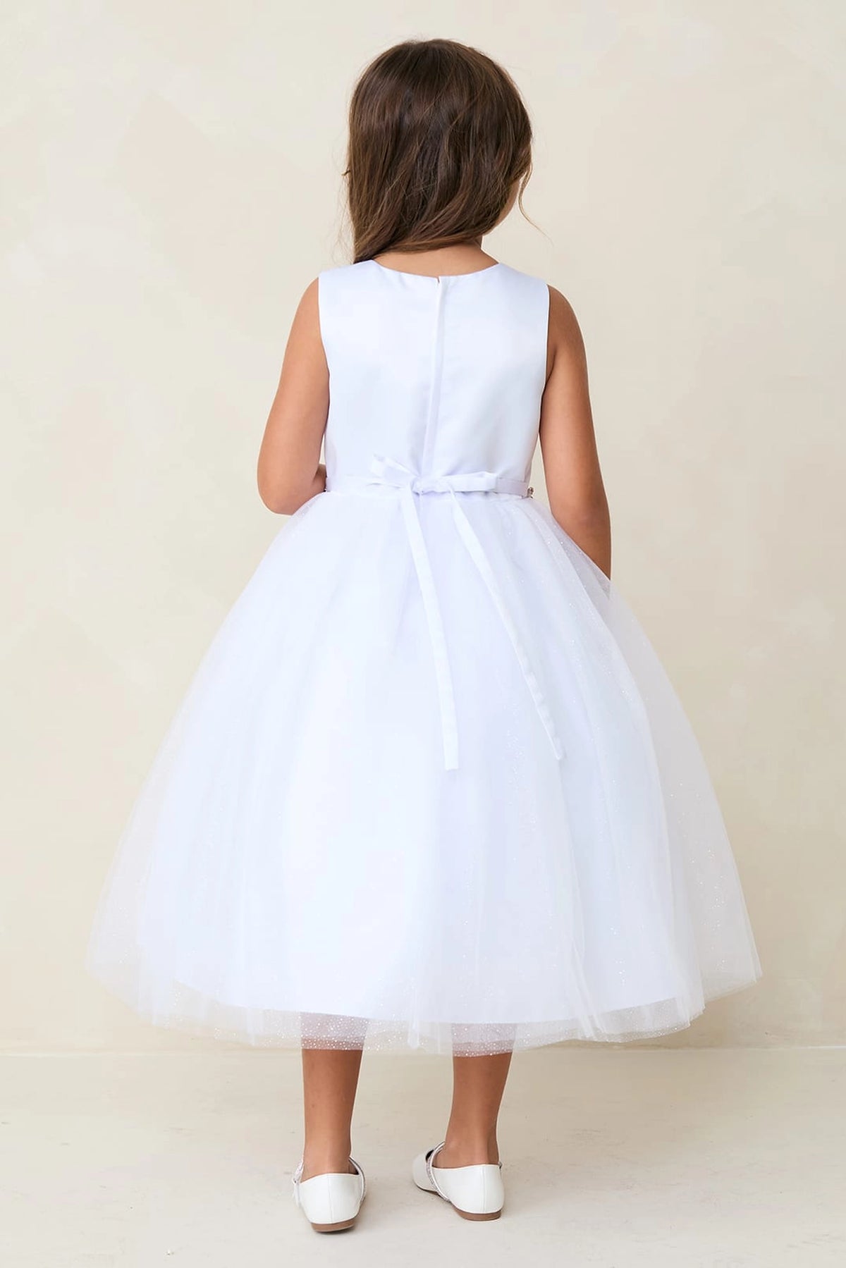 The White kids pageant dress has a tied sash across the back waist.
