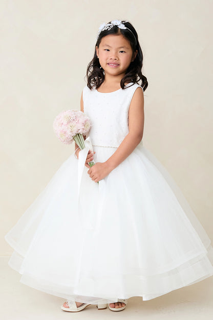 This off-white flower girl dress displays a fine pleated skirt.