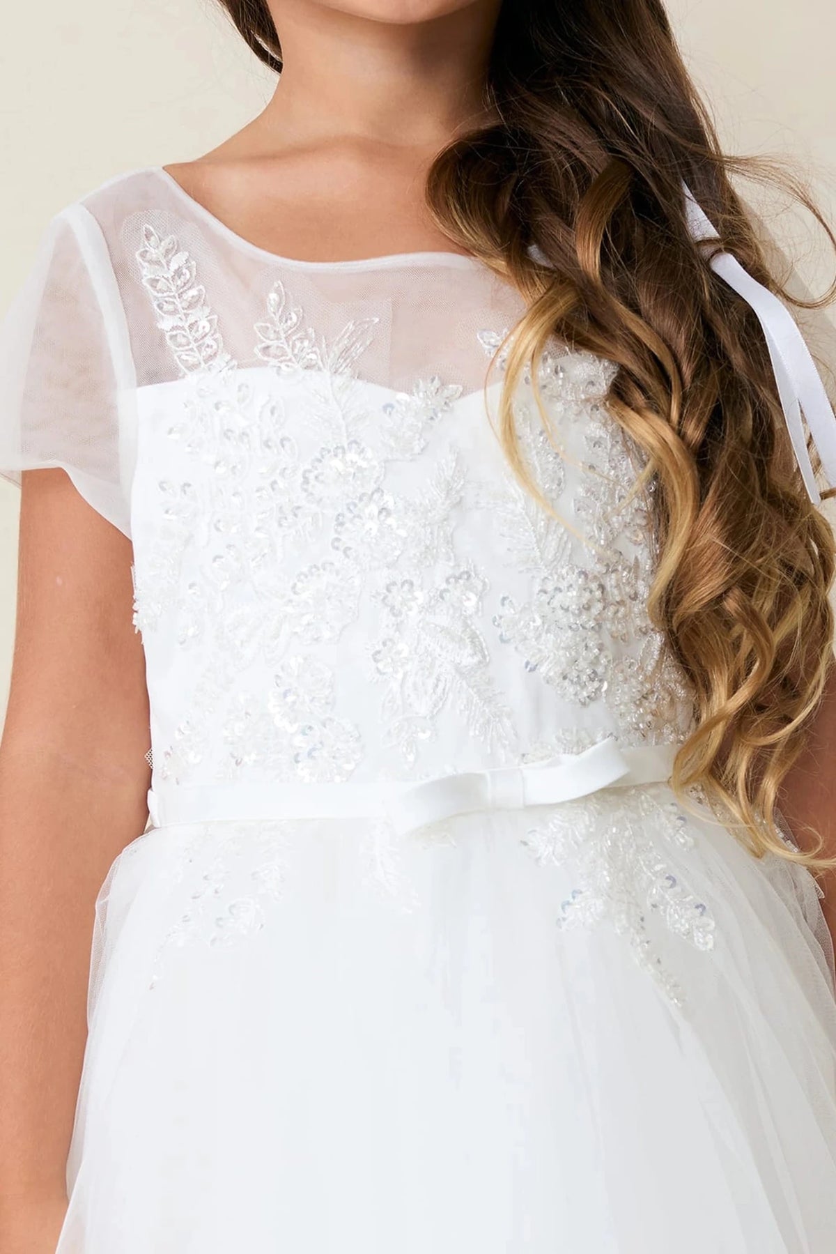 Off-White flower girl dress detailed with a sheer floral neckline.