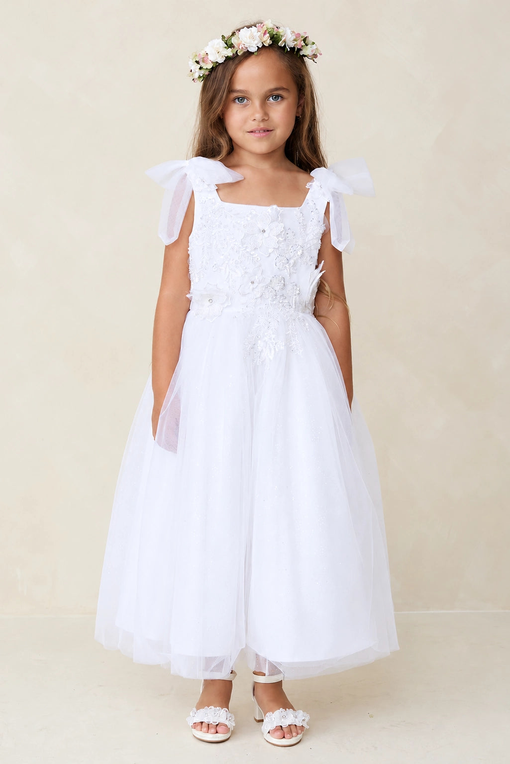 Full tulle skirt shown on the white flower girl dress.