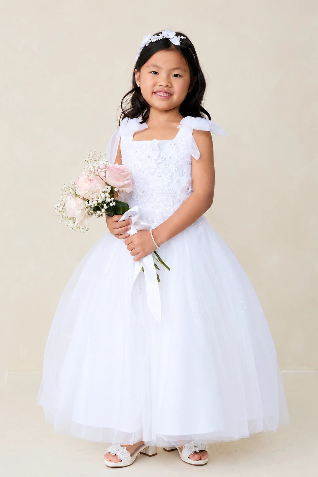 With a 3D flower bodice, a white flower girl dress.