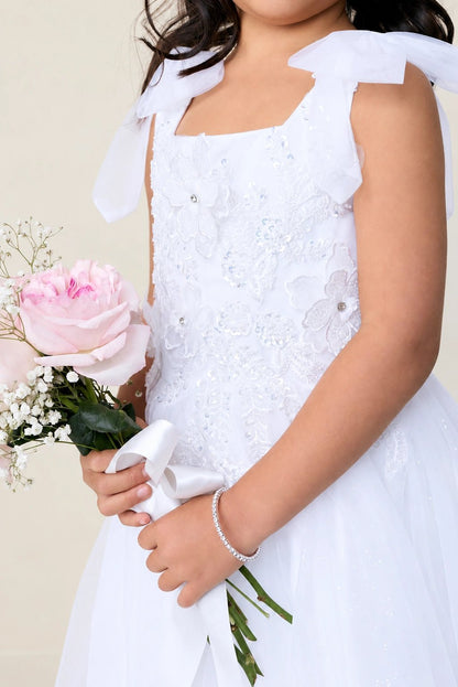 The white flower girl dress features 3D flower appliques.