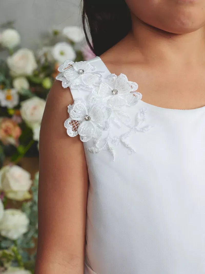 The off-white flower girl dress features 3D shoulder flower.