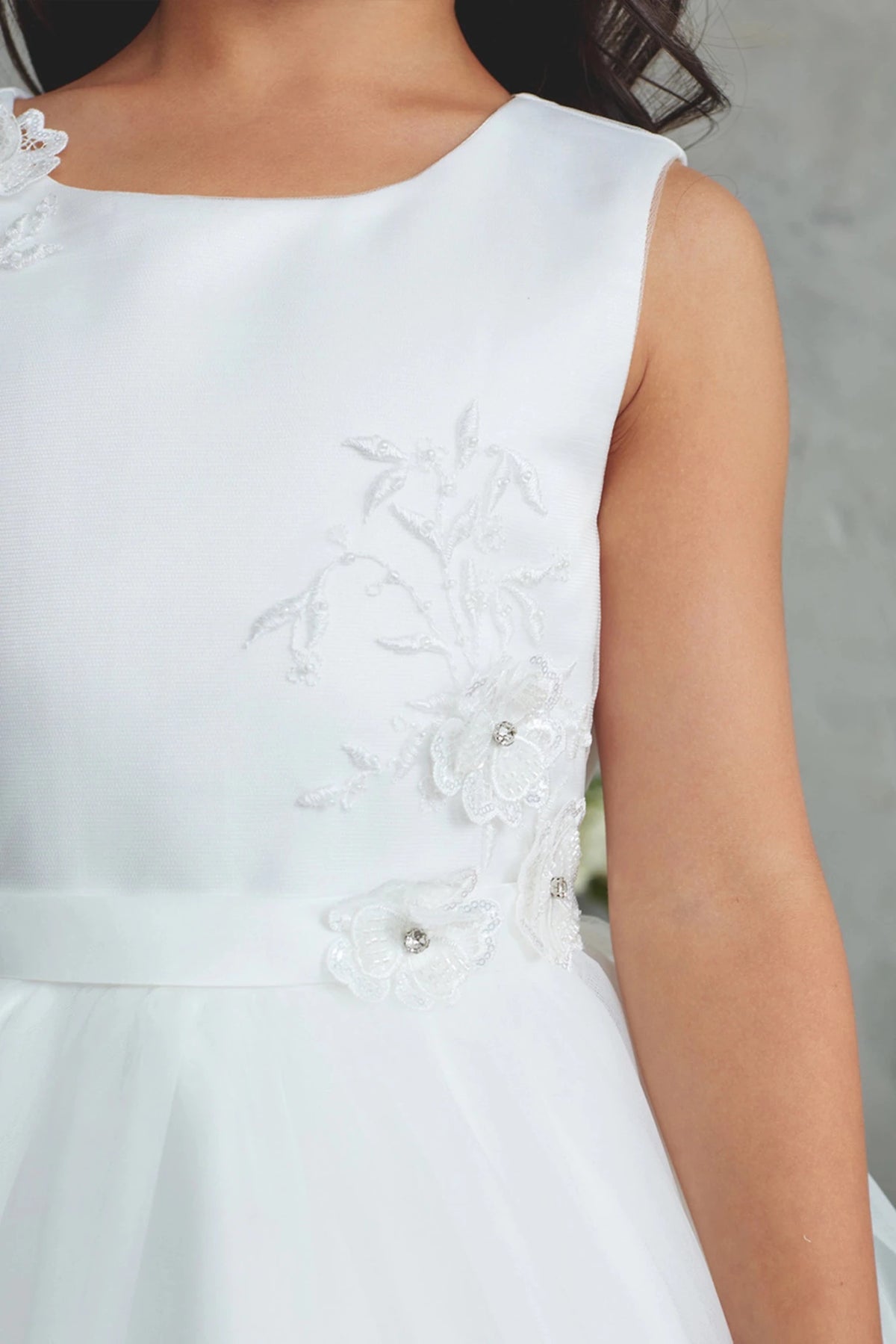 White flower girl dress with floral waist embroidery.