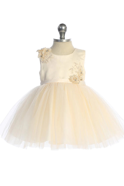 This champagne flower girl dress displays floral bodice accents.
