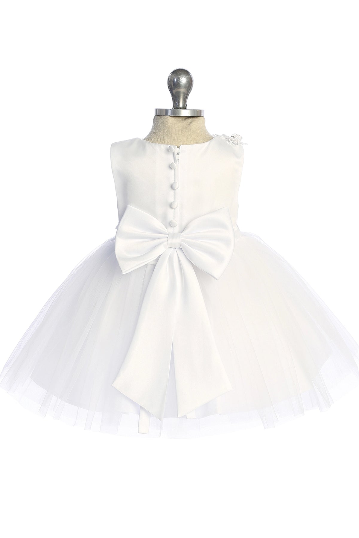 Highlighting a large satin back bow on a white flower girl dress.