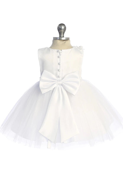 Highlighting a large satin back bow on a white flower girl dress.