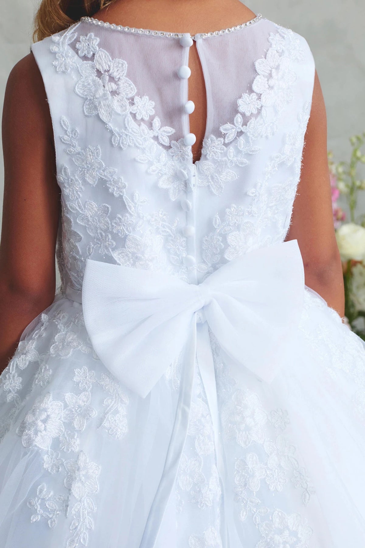 With pearl-trimmed lace back, a white flower girl dress.