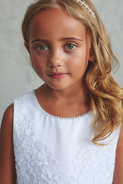 Focus on a pearl round neckline of the white flower girl dress.