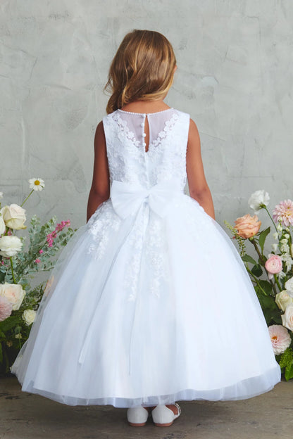 Emphasis on a large satin bow of the white flower girl dress.
