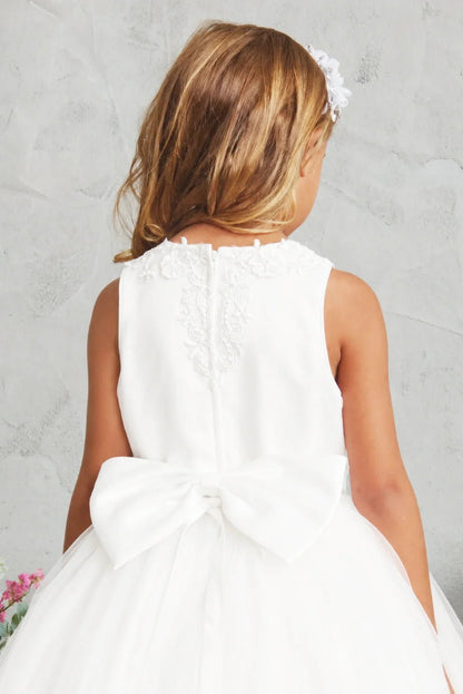 Oversized satin bow on an off-white flower girl dress.