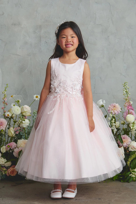 Blush flower girl dress with a floral waist applique.