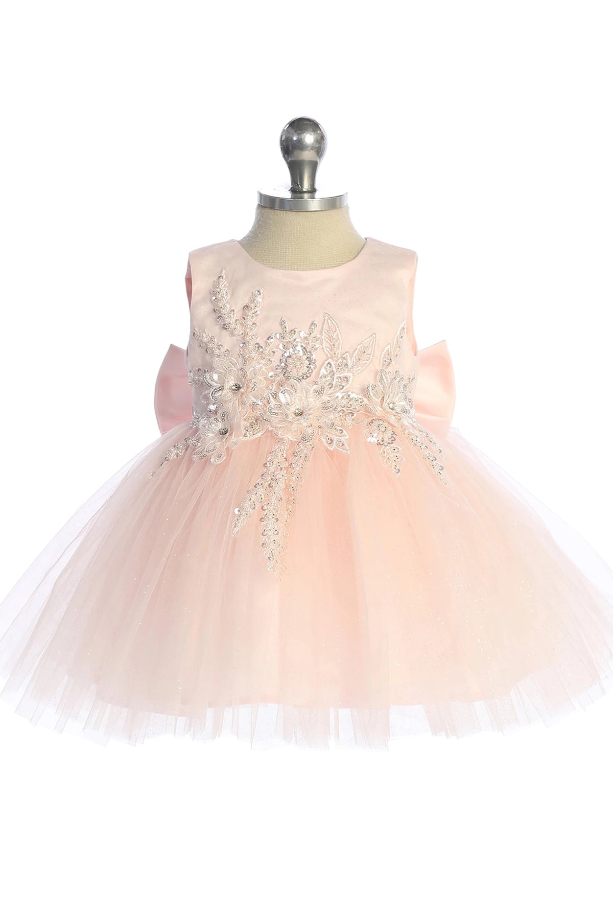 Floral waist applique is visible on the blush flower girl dress.