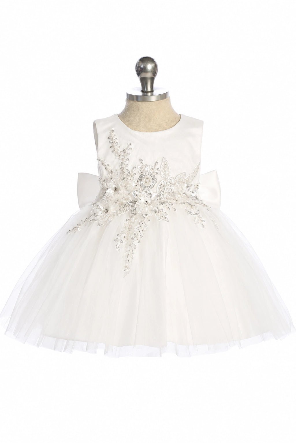 This off-white flower girl dress displays a rhinestone leaf pattern.