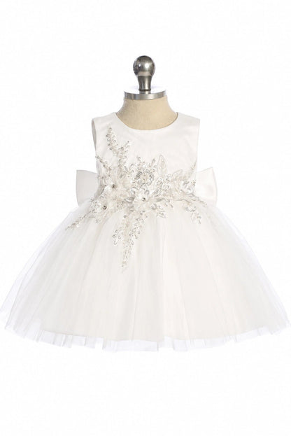 This off-white flower girl dress displays a rhinestone leaf pattern.