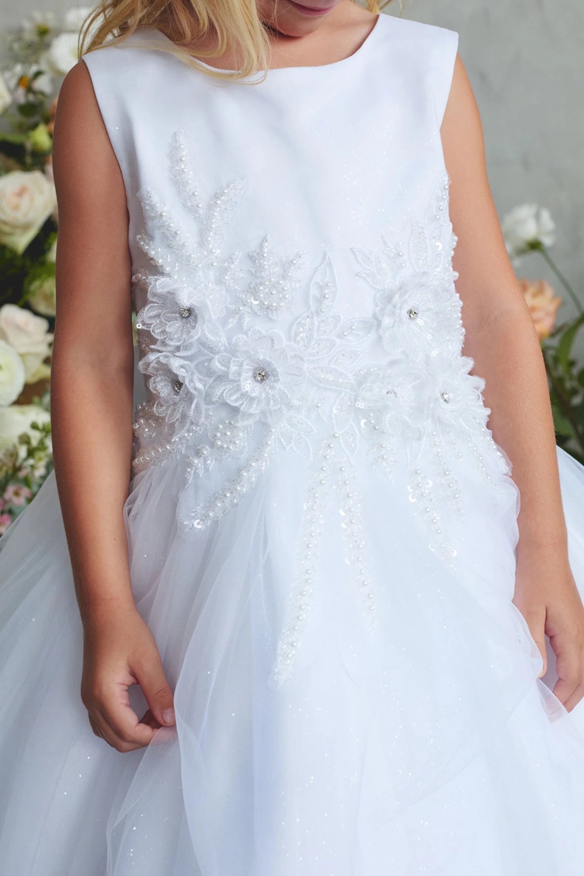 This white flower girl dress displays a 3D flower waist.