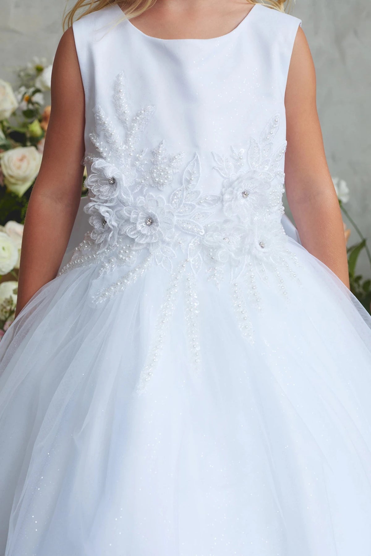 Rhinestone floral spray shown on the white flower girl dress.