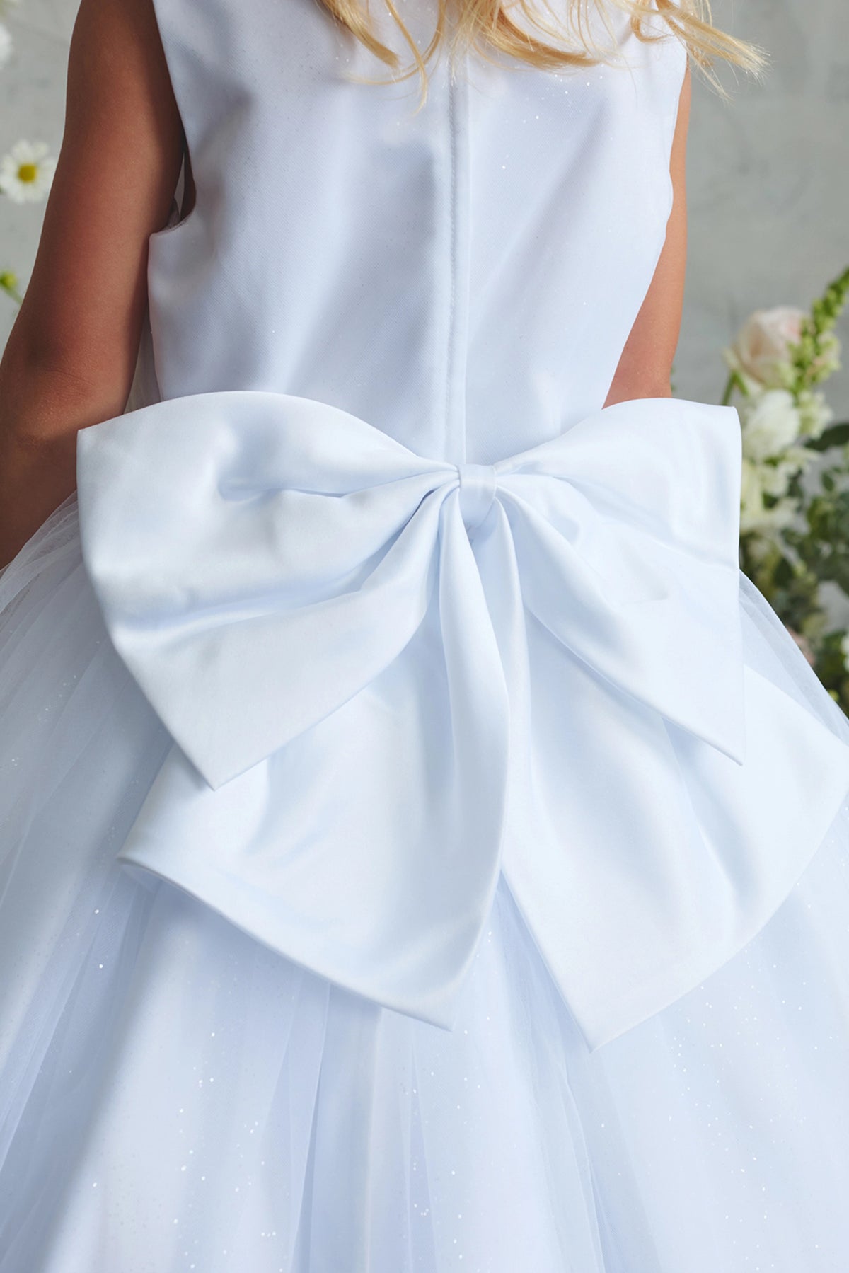 White flower girl dress with a large satin back bow.