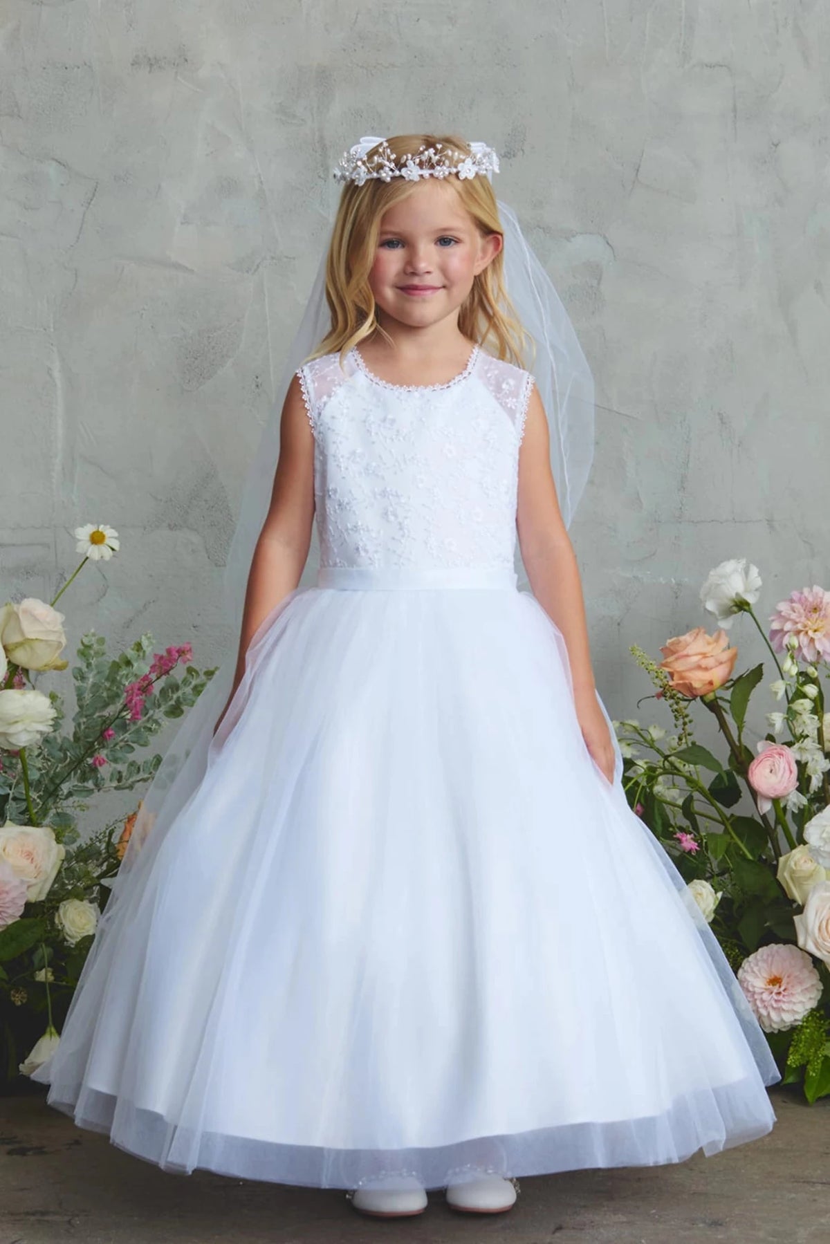 Beaded lace bodice on a white flower girl dress.