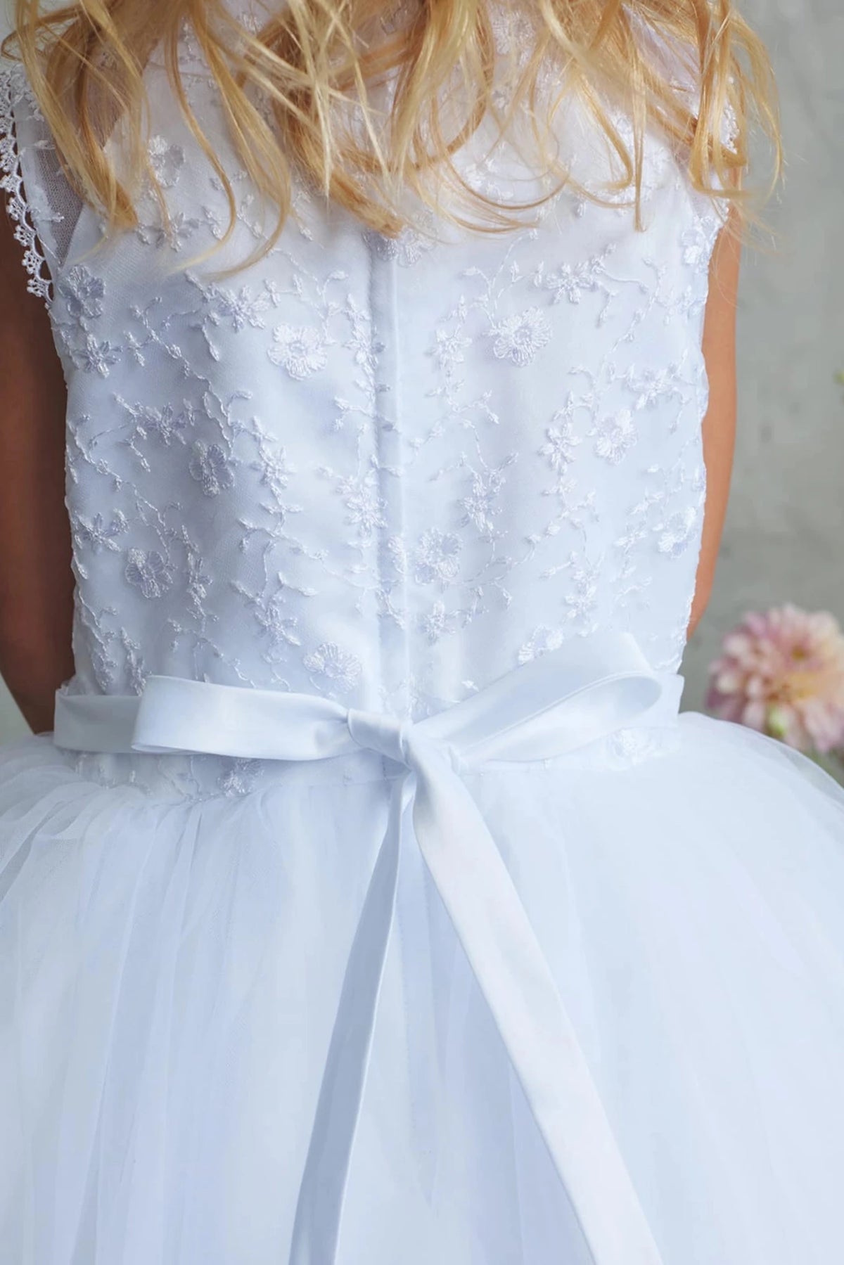 Fine back lace on a white flower girl dress.