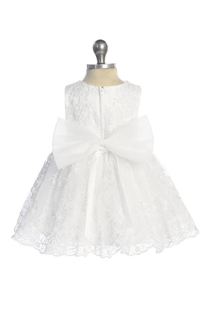 White flower girl dress featuring a large satin back bow.