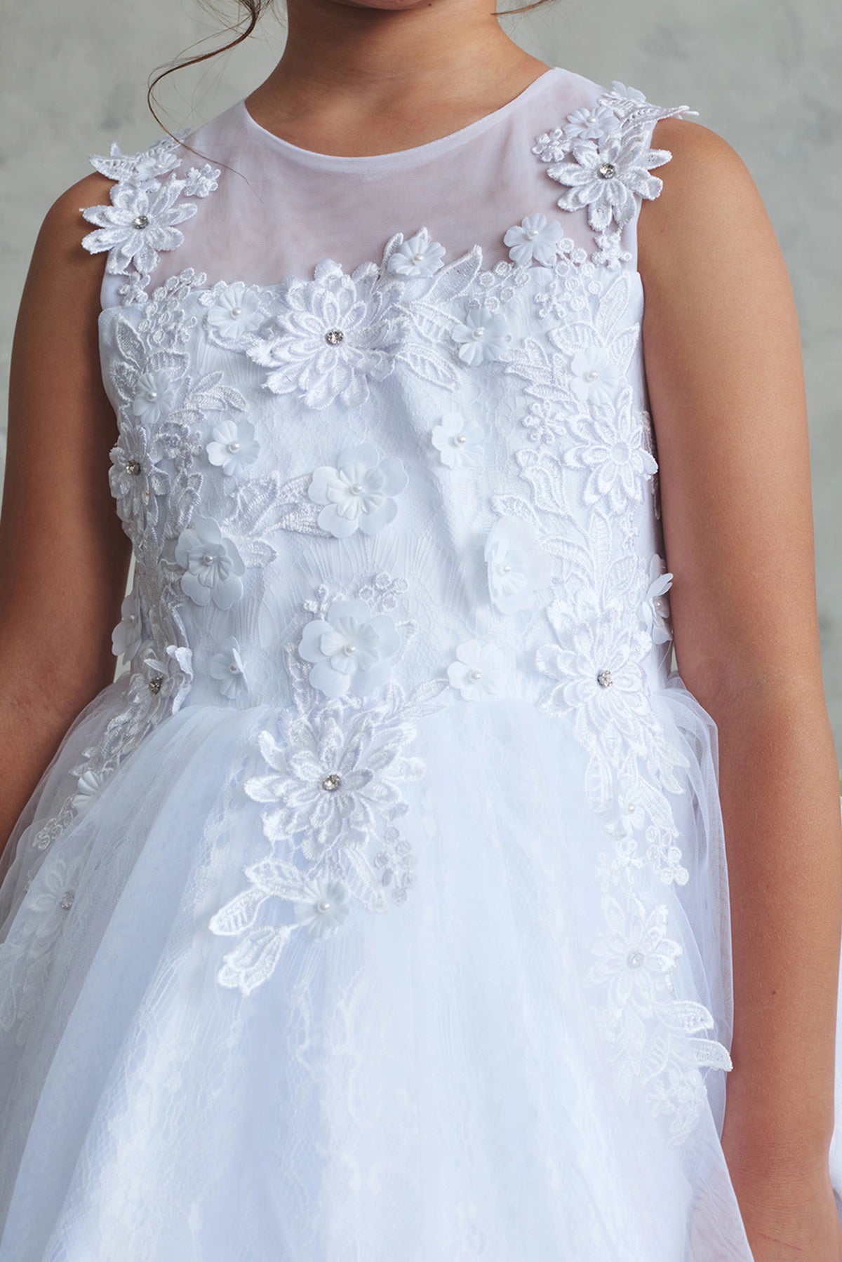White flower girl dress detailed with a flower applique neckline.