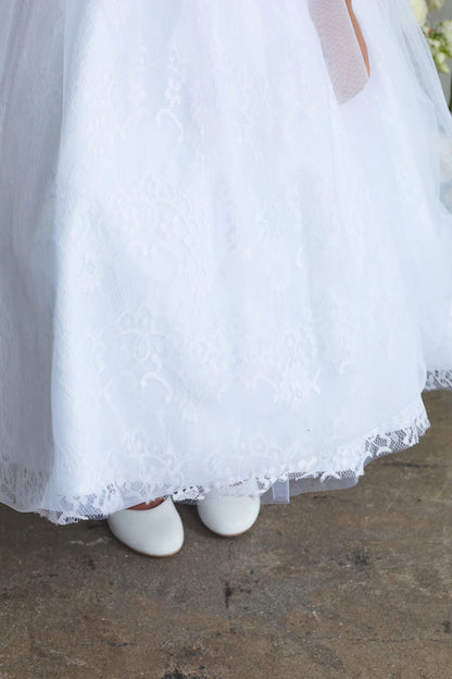 Scalloped floral hem on a white flower girl dress.