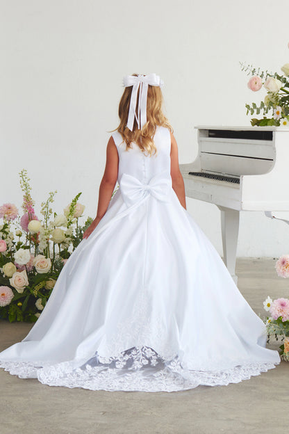 Lace-trimmed back train: detail of the white flower girl dress.