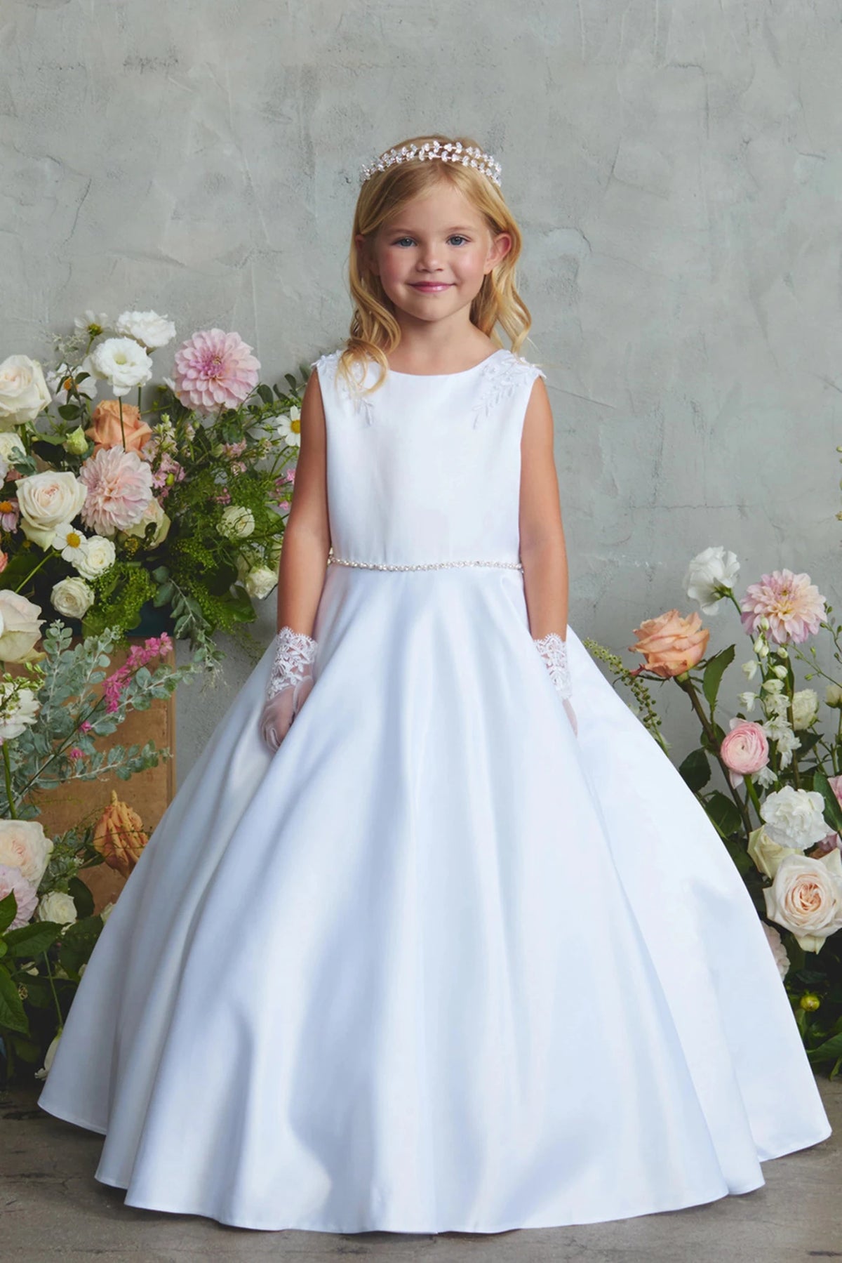 Wide satin hem on a white flower girl dress.