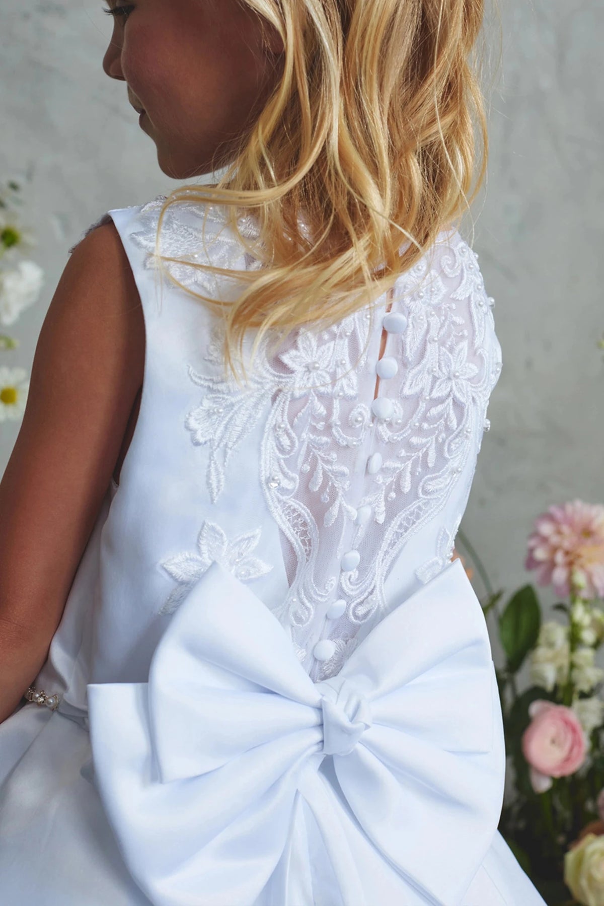 Visible on the white flower girl dress: sheer lace back.