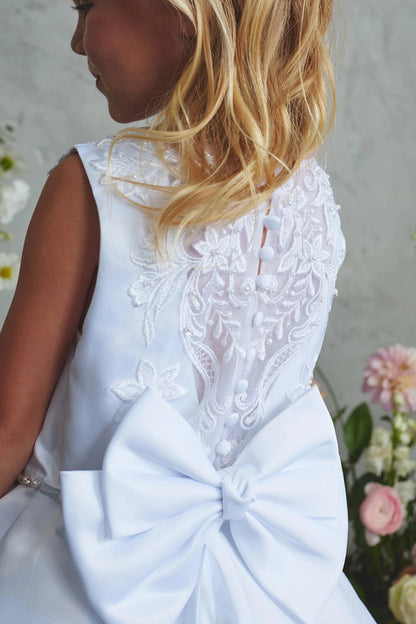 Visible on the white flower girl dress: sheer lace back.
