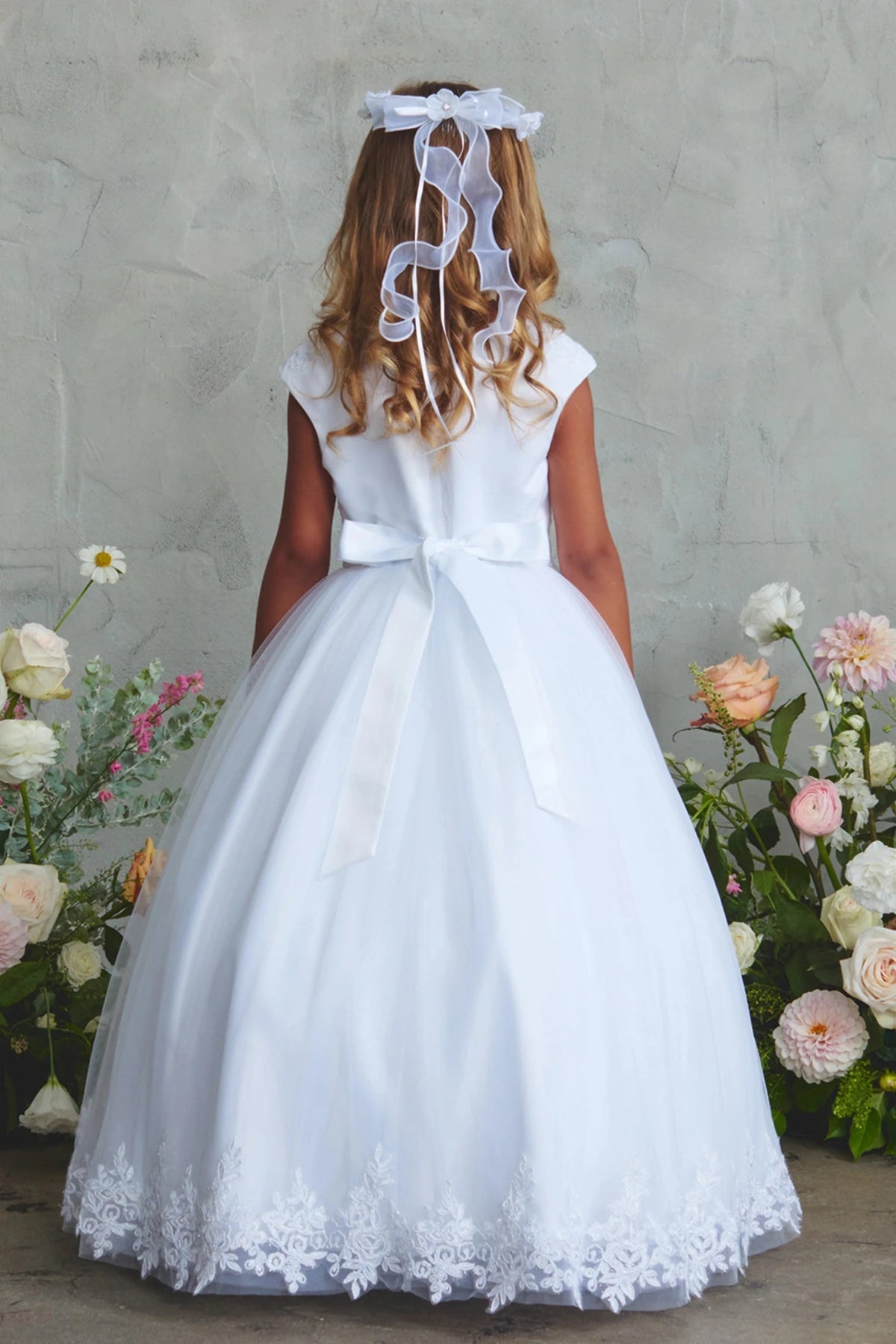 Slender satin back bow shown on the white flower girl dress.