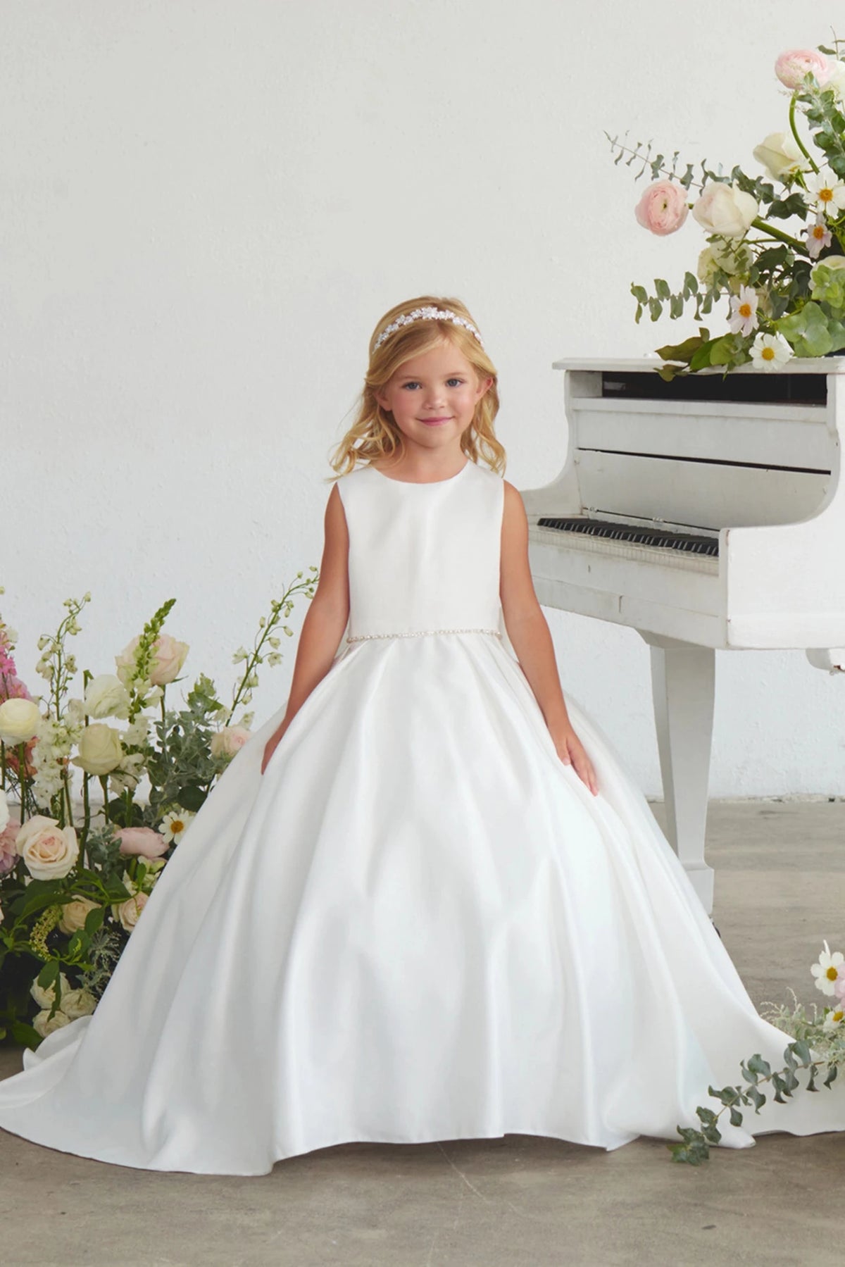Smooth satin bodice is visible on the white flower girl dress.