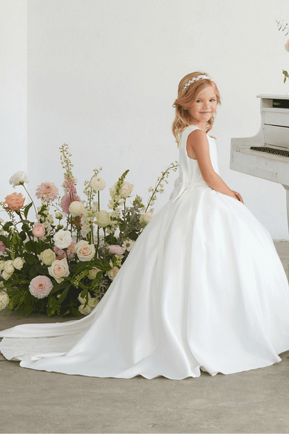 Full pleated skirt accents the white flower girl dress.