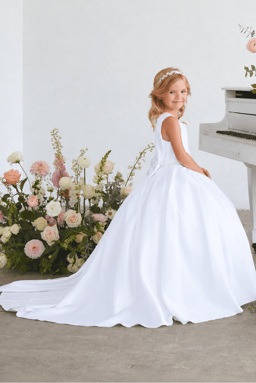Side view of Tiptop 5925 white satin flower girl dress with a full skirt and sweeping train.