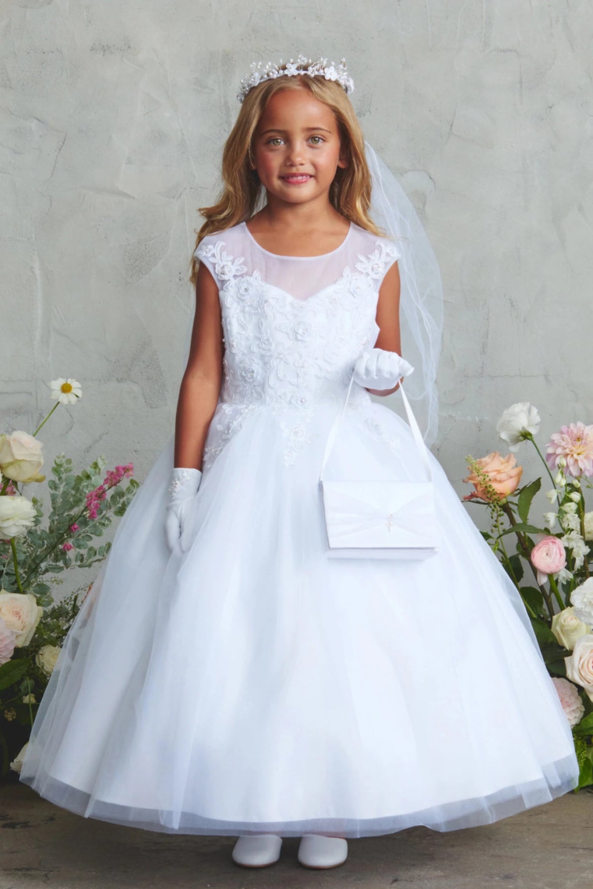 Floral bodice lace on a white flower girl dress.