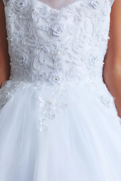 On this white flower girl dress, flowing floral embroidery is visible.