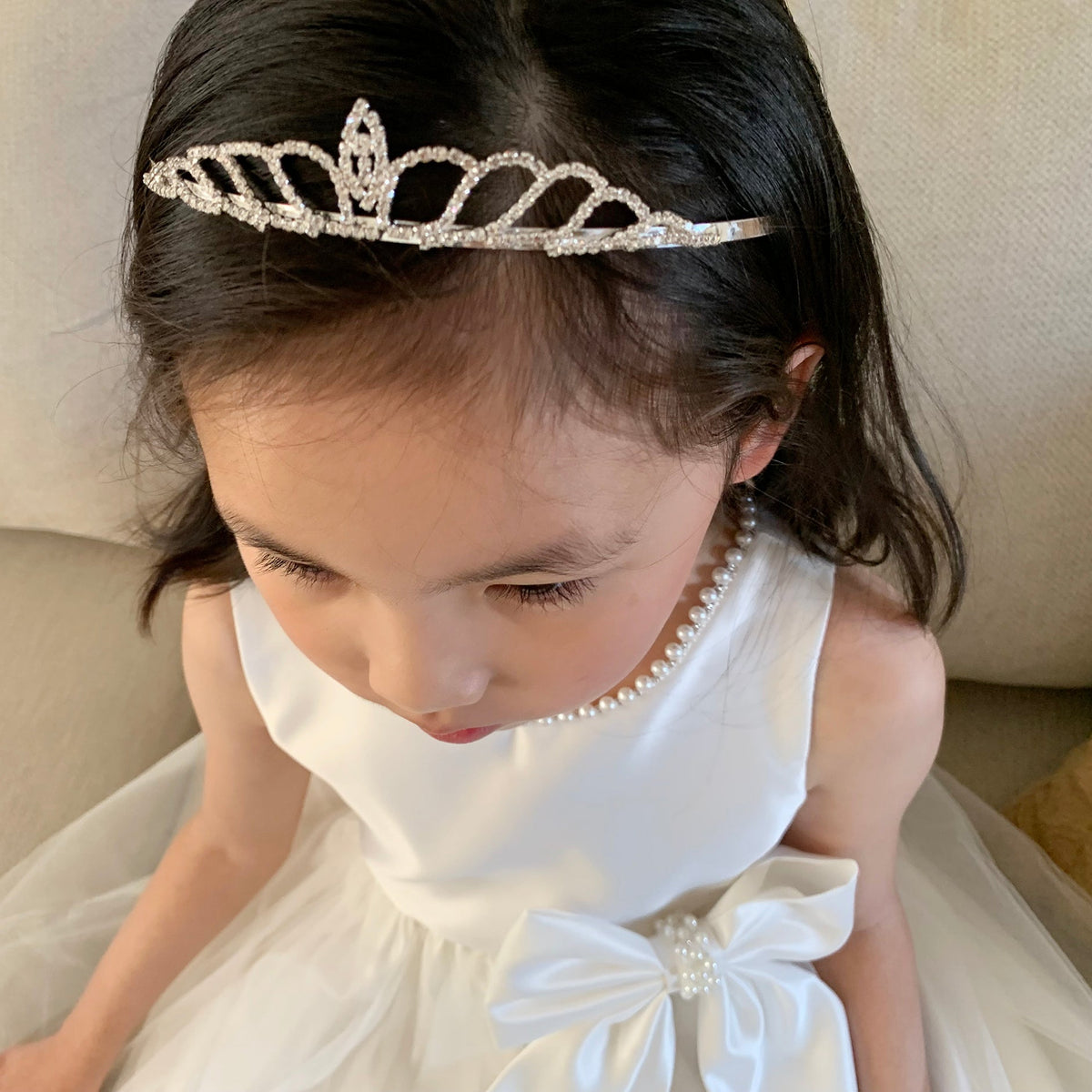 Silver rhinestone flower girl tiara, top view.