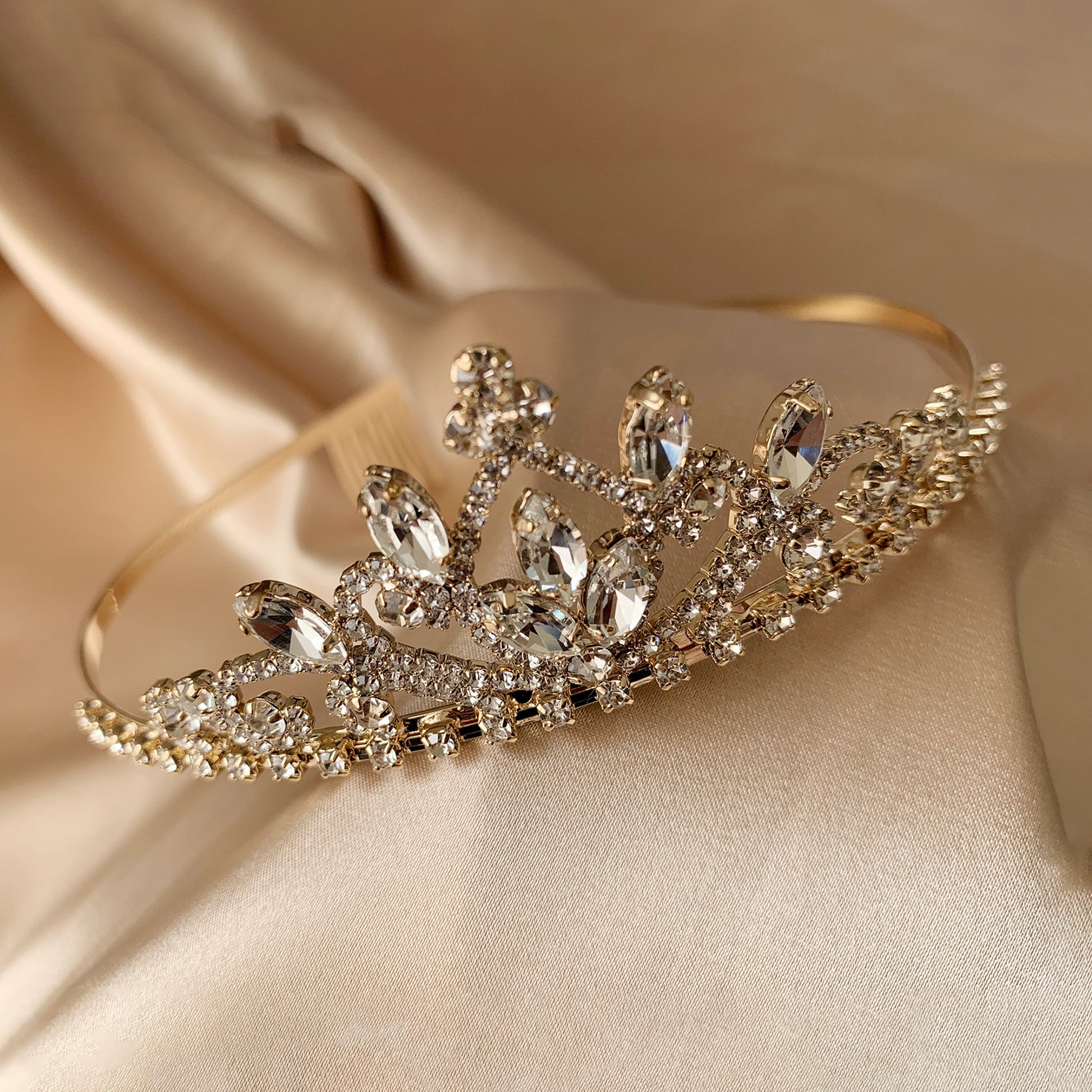 Gold rhinestone flower girl tiara, close-up, front view, embellishment detail.