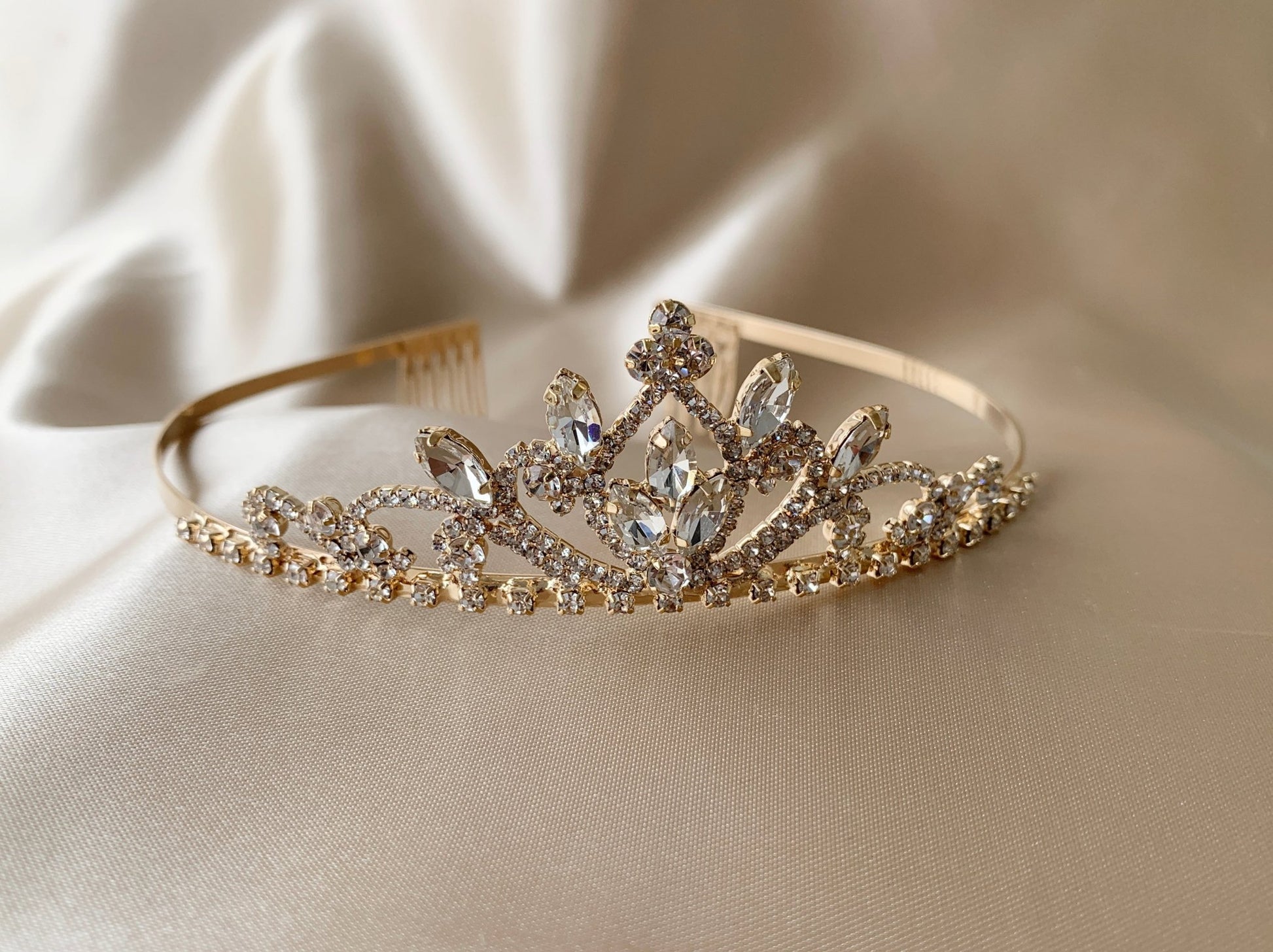 Gold rhinestone flower girl tiara, close-up, embellishment detail.