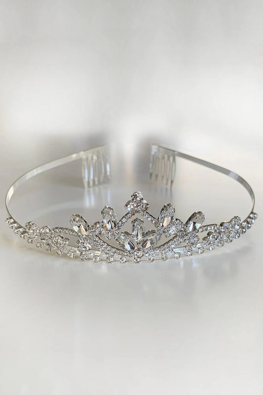 Silver tiara with clear gemstones on a white background