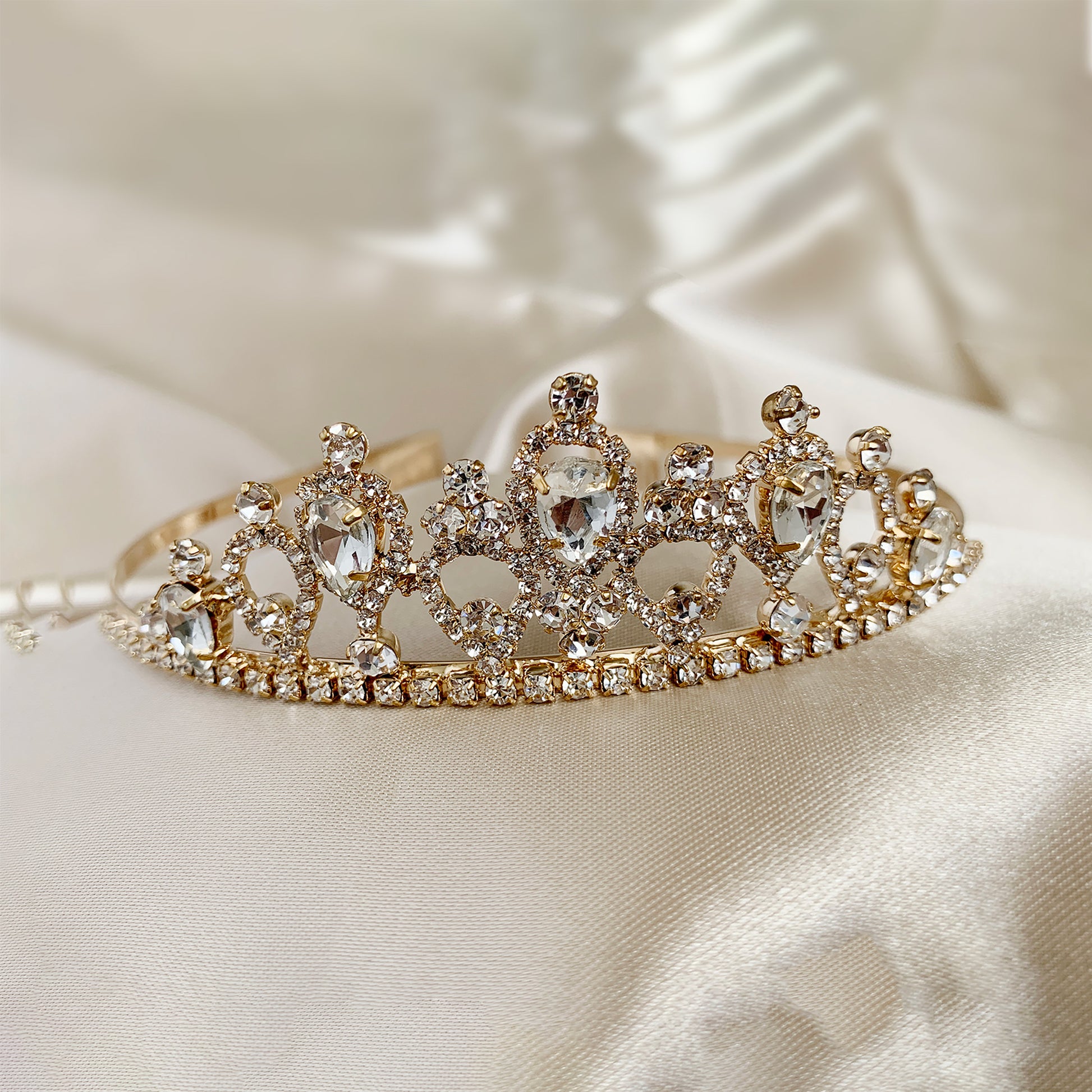 Gold rhinestone flower girl tiara, close-up, embellishment detail.