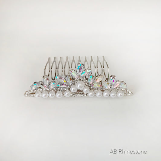 Silver hair comb with pearls and AB rhinestones on a white background