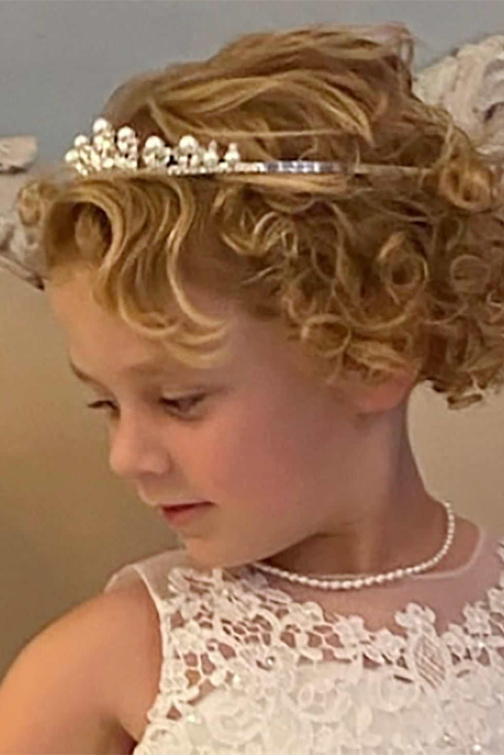 Silver pearl rhinestone flower girl and first communion tiara and two-tier veil, side view.