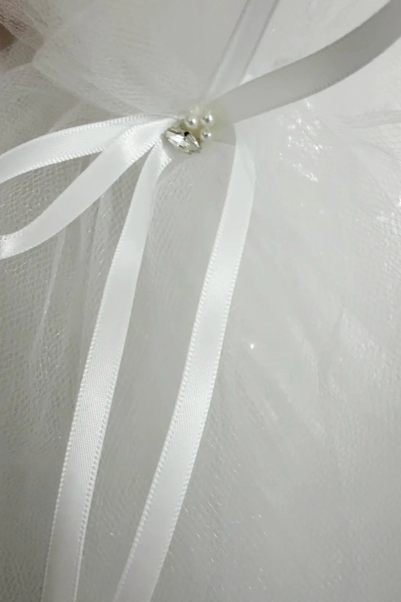 Silver pearl rhinestone flower girl and first communion tiara and two-tier veil, bow detail.