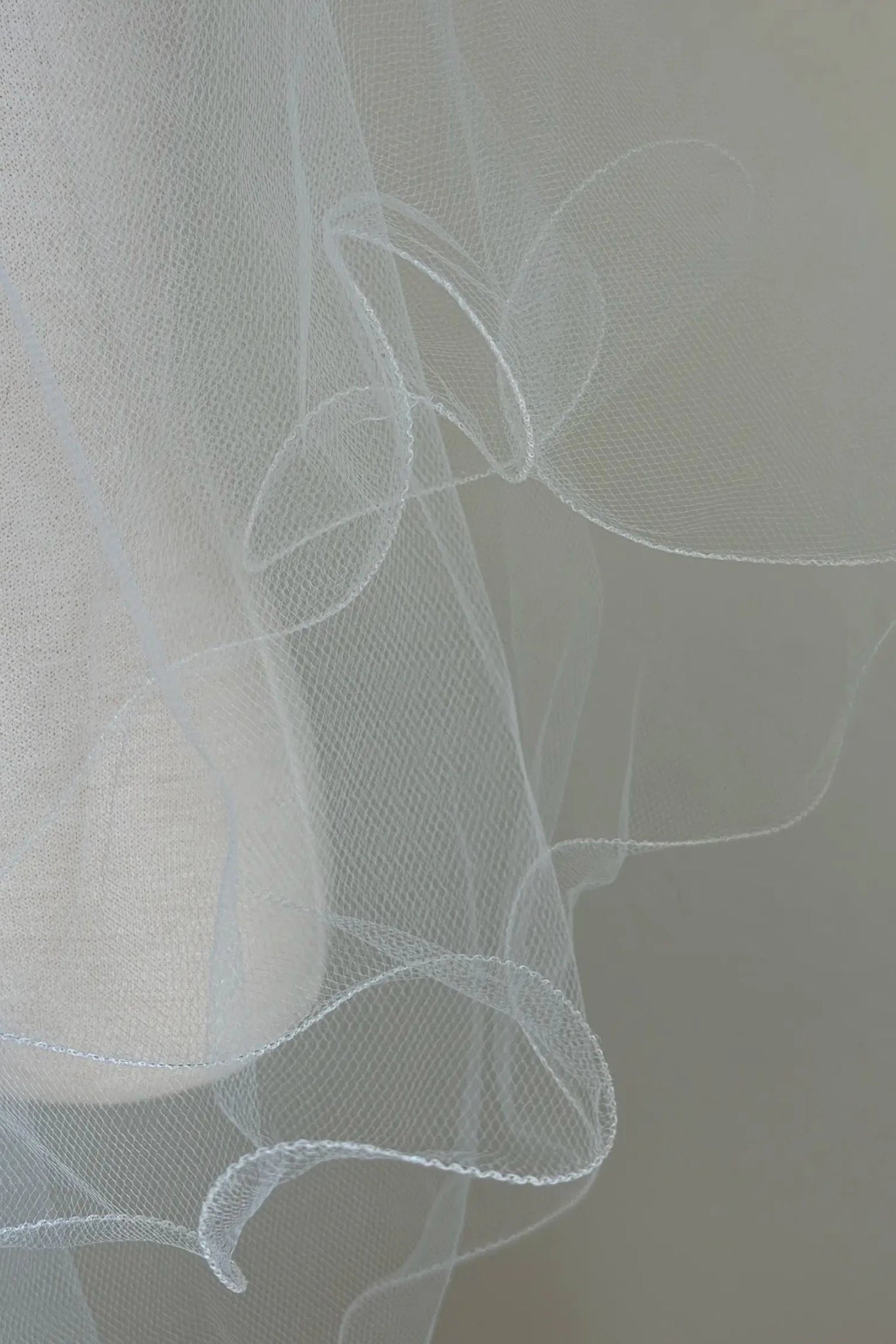 White pearl rhinestone flower girl and first communion tiara and two-tier veil, close-up.