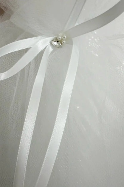 Textured details appear across tiara with multi color pearl rhinestone flower girl and first communion tiara and two-tier veil.