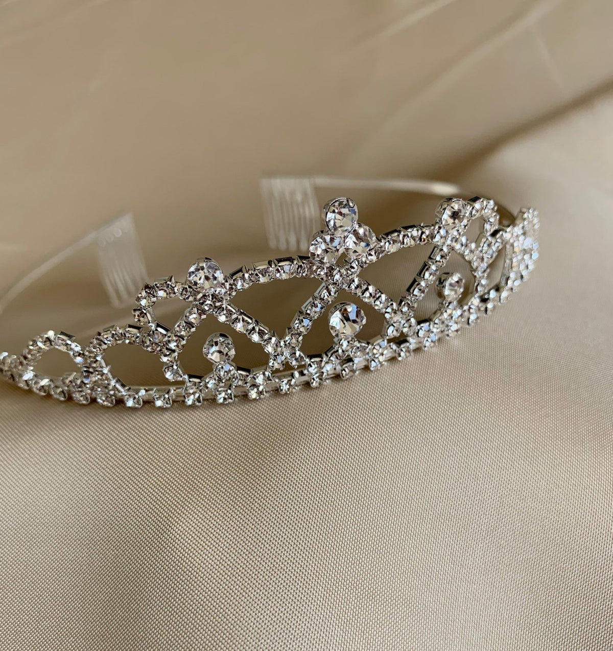 Multi color rhinestone flower girl and first communion tiara and two-tier veil, close-up, embellishment detail.