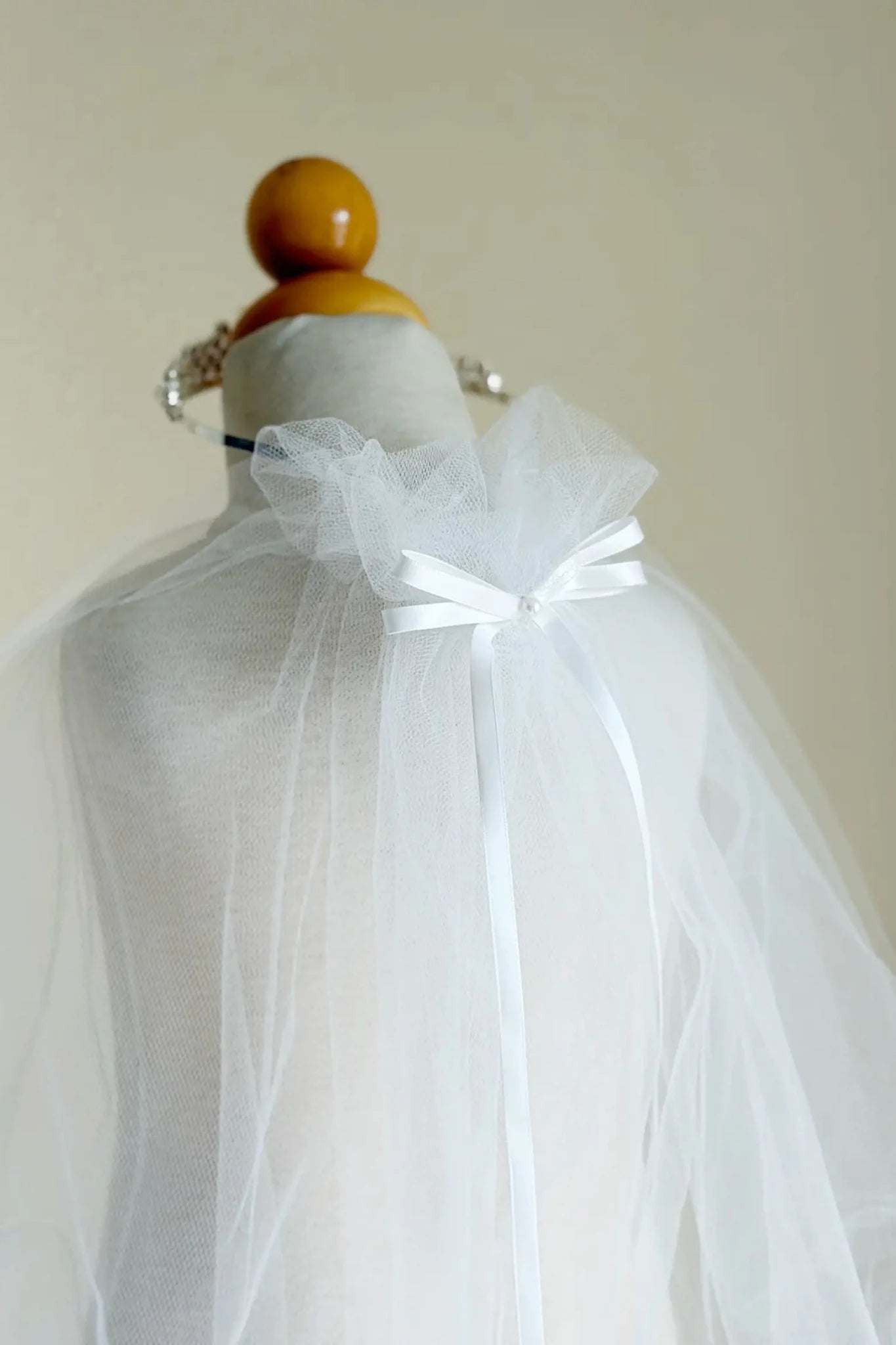 White rhinestone tulle flower girl and first communion tiara and two-tier veil.