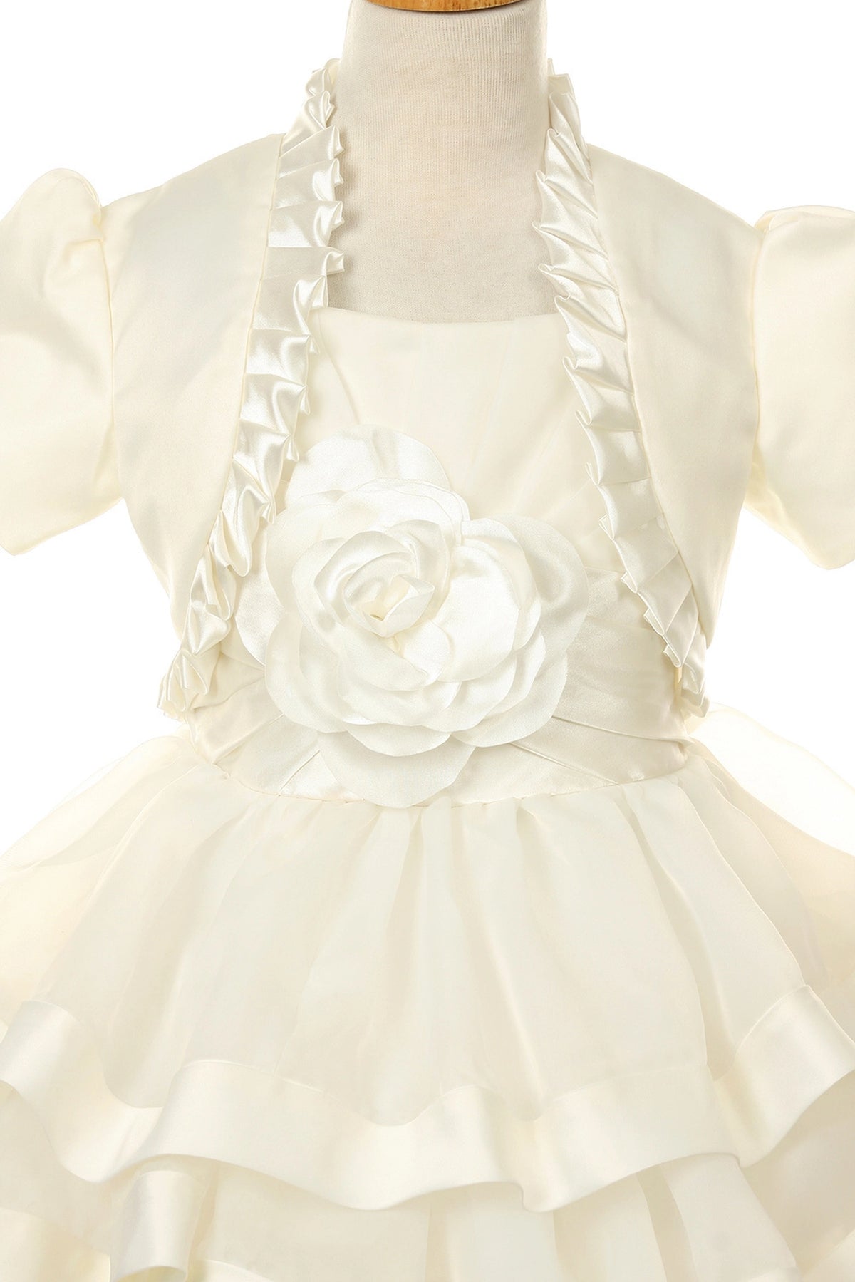Showcasing with horizontal skirt ruffles, this Ivory kids party dress displays elegant detail.